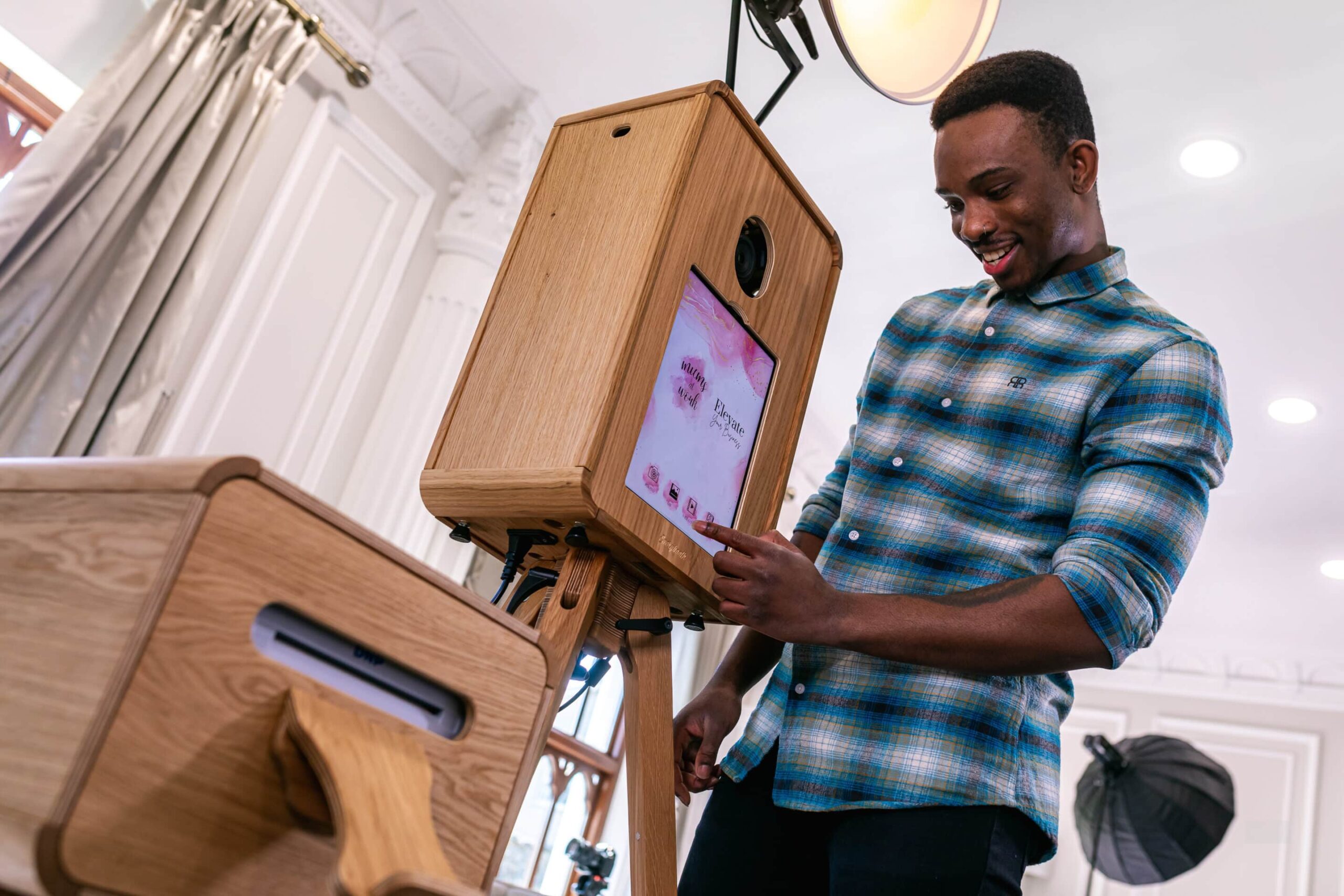 Guy interacting with photo booth setup