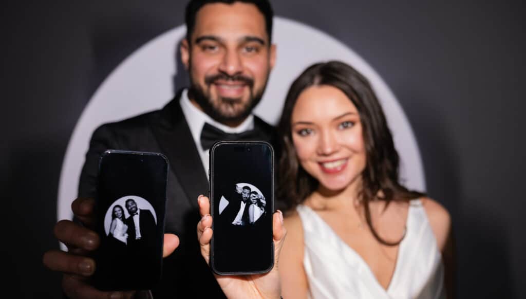 couple using a wedding photo booth rental