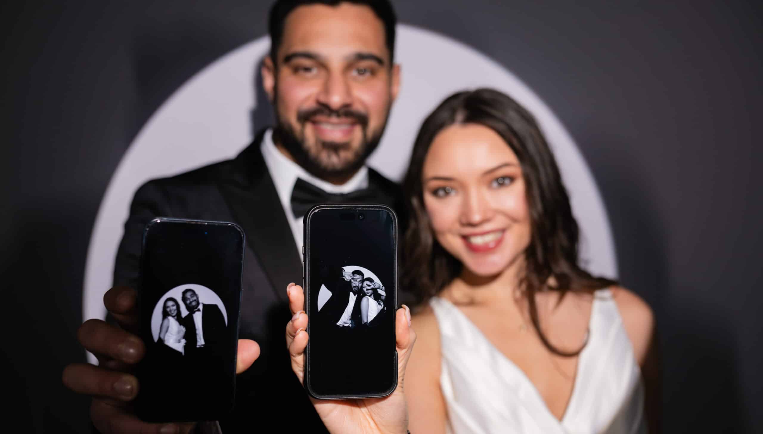 couple using a wedding photo booth rental