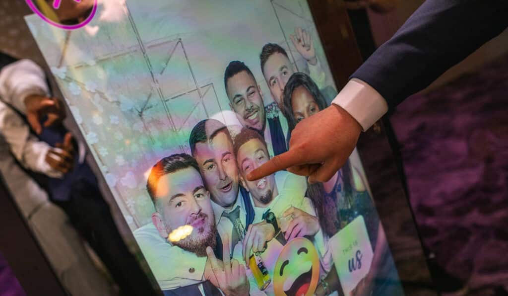 Wedding guests engaging with photo booth