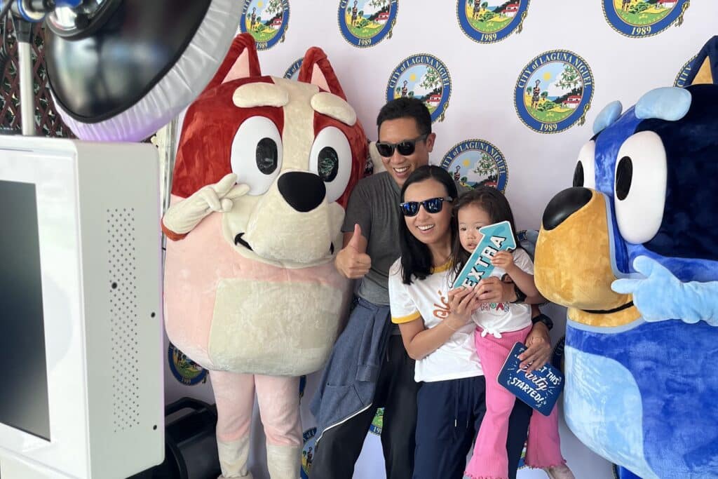 Family taking an image with a photo booth with Bluey characters