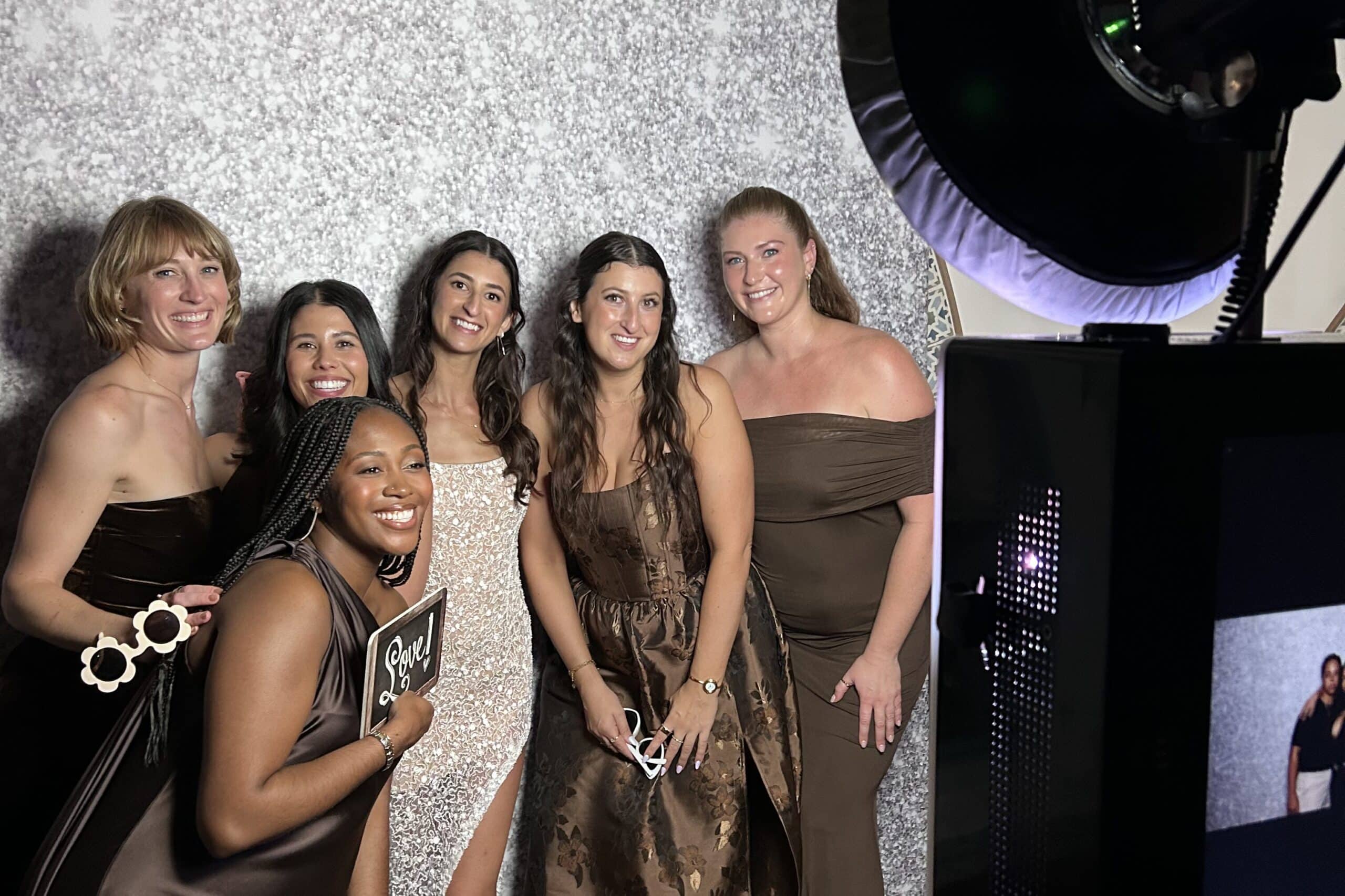 Group of friends taking an image with a photo booth